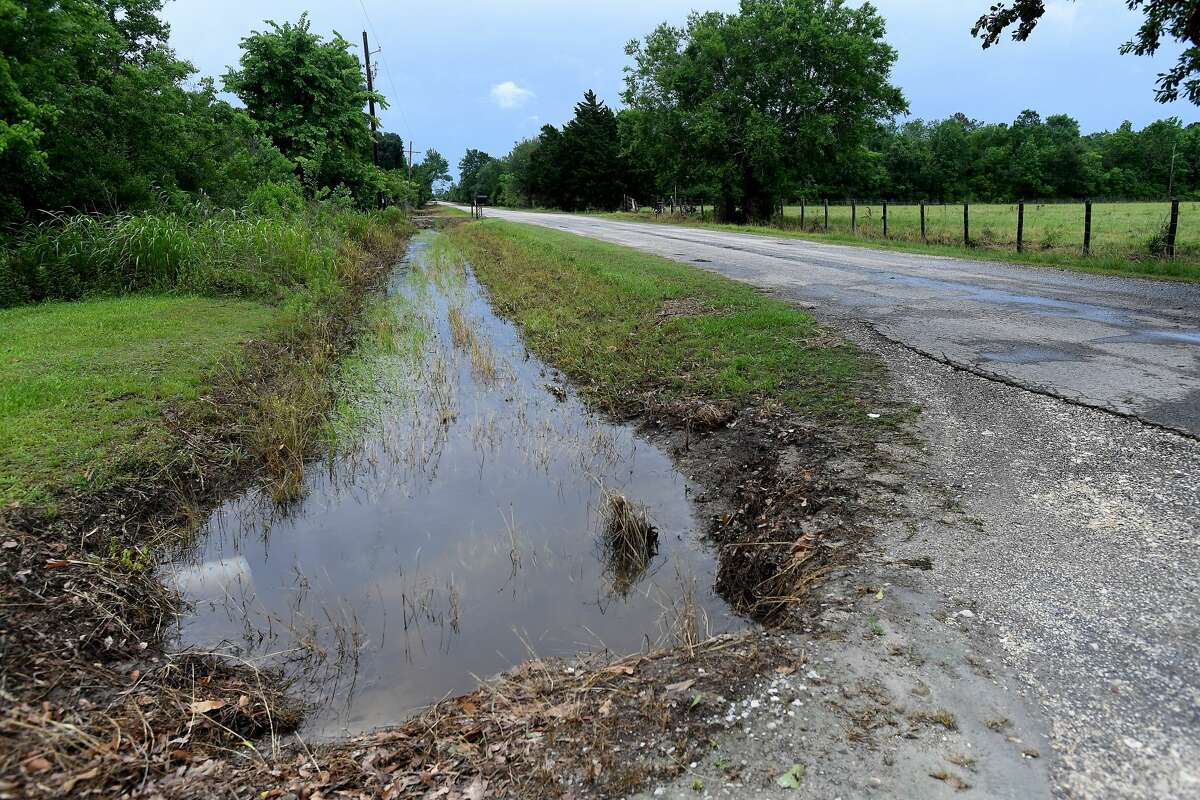 The drainage system into which the ditch behind Julie Meadows' home in Fannett should feed is well below flood stage, with little water movement evident Tuesday. Meadows' home and several properties on West Clubb Road flooded after the area received over a foot of rainfall Monday. Photo made Tuesday, May 18, 2021 Kim Brent/The Enterprise