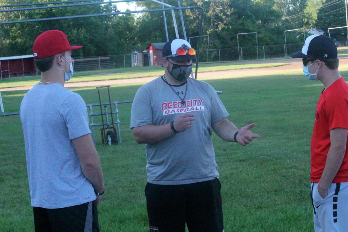 Reed City baseball coach Eric Grannis (center) and his team hopes for a strong finish to the season. (Herald Review file photo)
