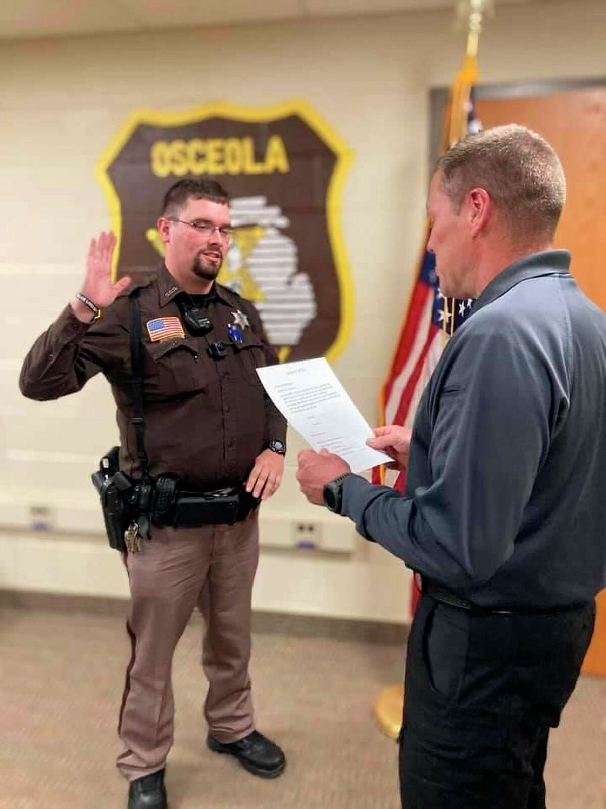 Deputy Ryan Douglas (left) was recently sworn in as the newest member of the Osceola County Sheriff's Office. (Submitted photo)
