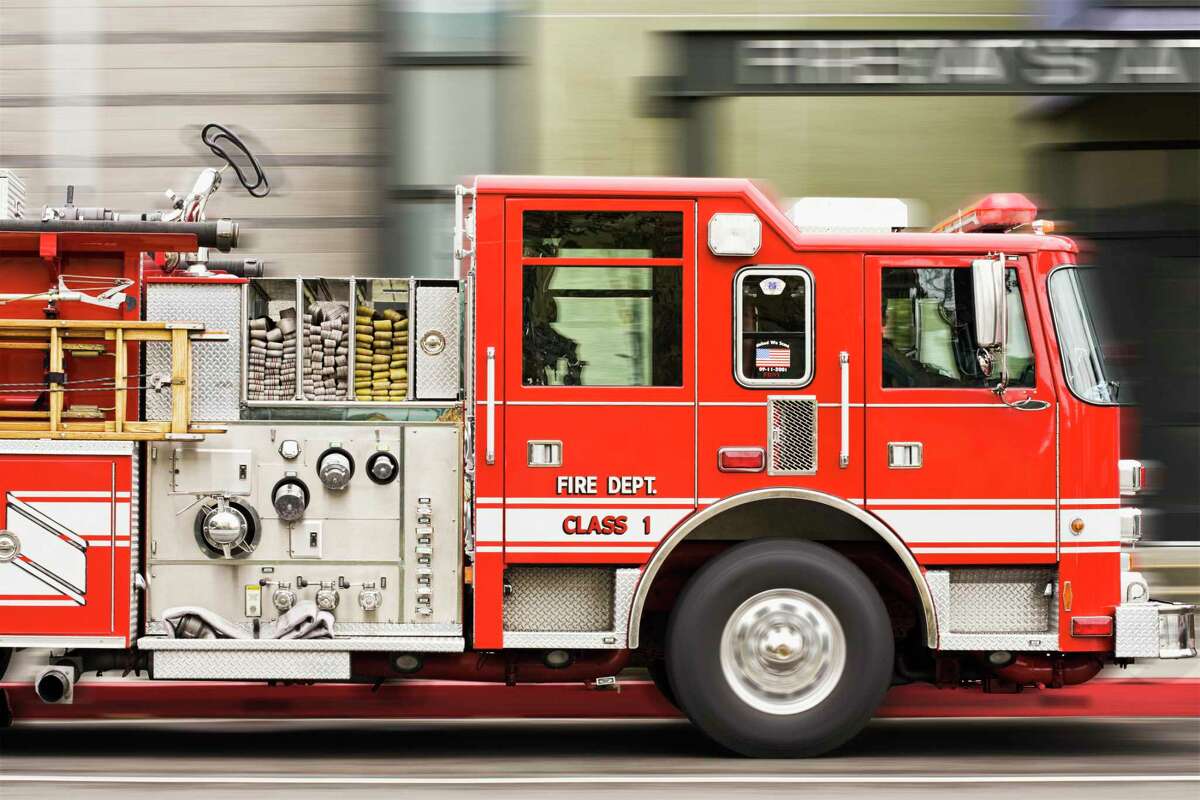 This file photograph shows a blurred view of fire truck driving in a city street.