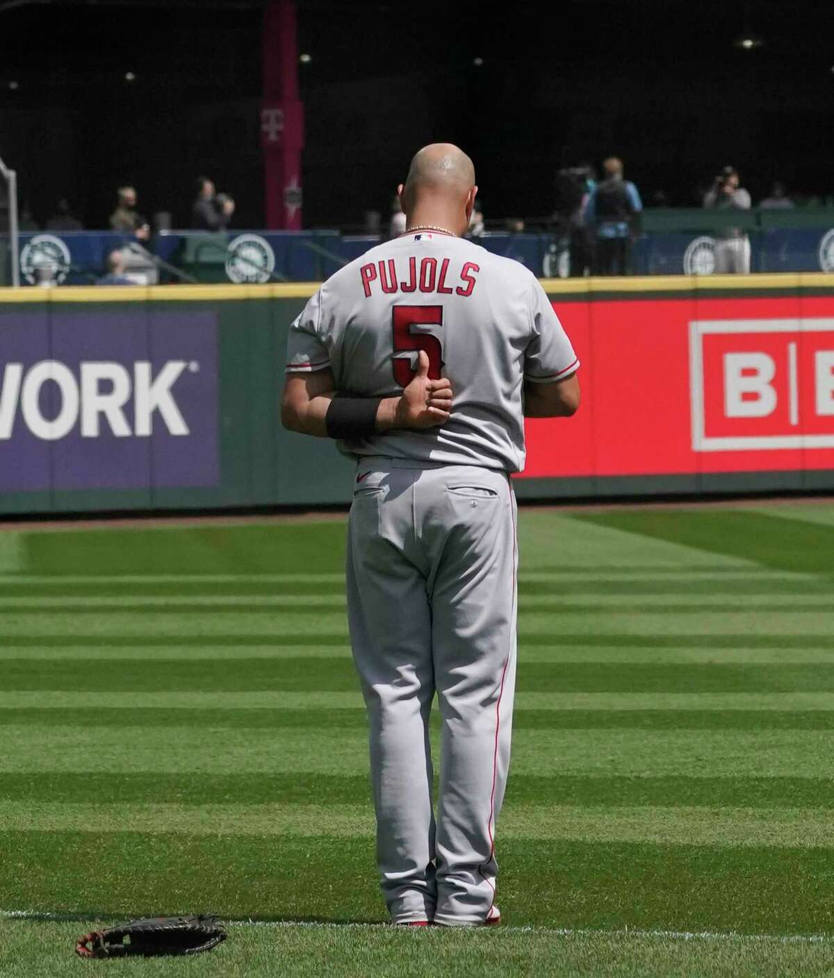 Los Angeles Angels' Albert Pujols stands during the national anthem, before a baseball game against the Seattle Mariners, Sunday, May 2, 2021, in Seattle. (AP Photo/Ted S. Warren)
