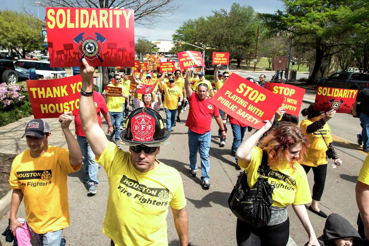 Houston firefighters a march on City Hall over a dispute related to Proposition B on Tuesday, March 19, 2019.