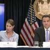 In this Sept. 14, 2018 file photo, Secretary to the Governor Melissa DeRosa, is joined by New York Gov. Andrew Cuomo as she speaks to reporters during a news conference, in New York. Top aides to Cuomo altered a state Health Department report to obscure the true number of people killed by COVID-19 in the state's nursing homes, The Wall Street Journal and The New York Times reported late Thursday, March 4, 2021. The aides, including DeRosa, pushed state health officials to edit the July report so only residents who died inside long-term care facilities, and not those who became ill there and later died at a hospital, were counted, the newspapers reported.(AP Photo/Mary Altaffer, File)