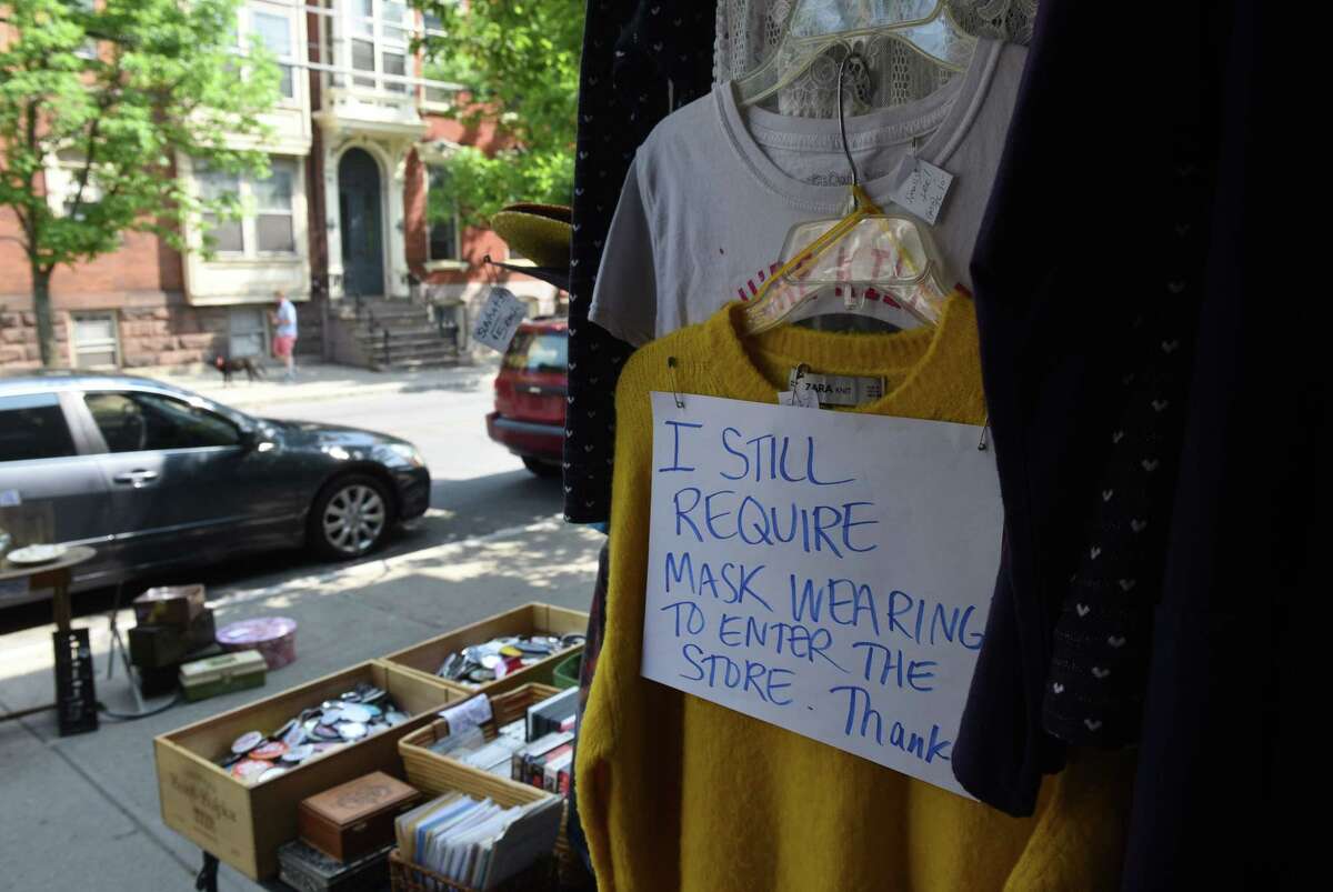 Sign asking patrons to wear a mask hangs in the doorway at Elissa Halloran Designs on Wednesday, May 19, 2021, on Lark Street in Albany, N.Y. (Will Waldron/Times Union)