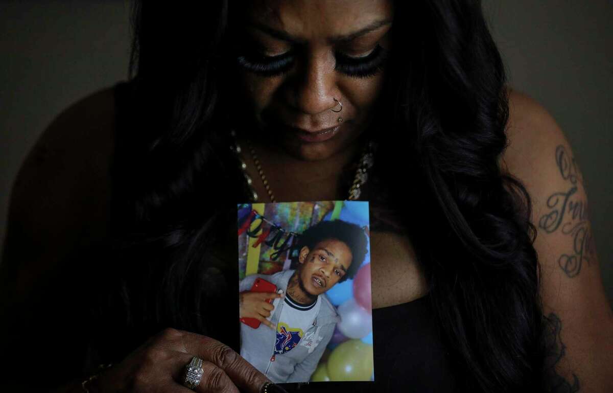 Larhonda Biggles with a photo of her late son, Jaquaree Simmons, on Wednesday, May 12, 2021, at her apartment in Houston.