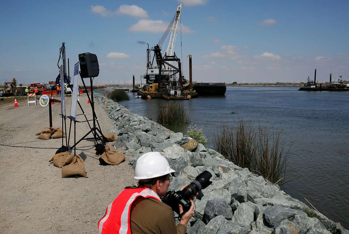Bill Kelley III shoots photographs for the state Department of Water Resources of the saltwater barrier construction in the delta in 2015. A similar rock wall is to be constructed in the same location starting next month.