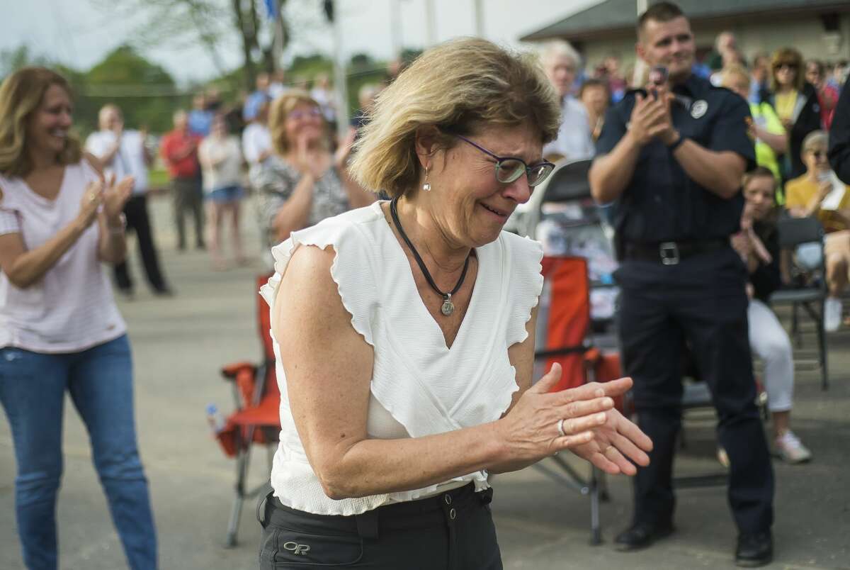In this file photo, Sanford Village President Dolores Porte reacts after the unveiling of a plaque in her honor during a dedication ceremony for the Sanford Veterans Monument and First Responders Monument in downtown Sanford.