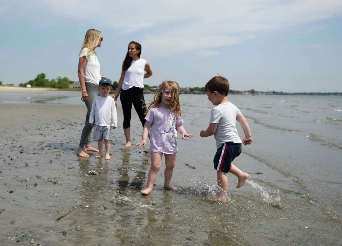 From left, Greenwich's Shevaun Lescoe, Finn Lescoe, 2, Riverside's Kristen Addeo, Emma Addeo, 3, and Riverside's Cole Campinell, 3, hang out on the beach at Greenwich Point Park in Old Greenwich, Conn. Thursday, May 20, 2021.