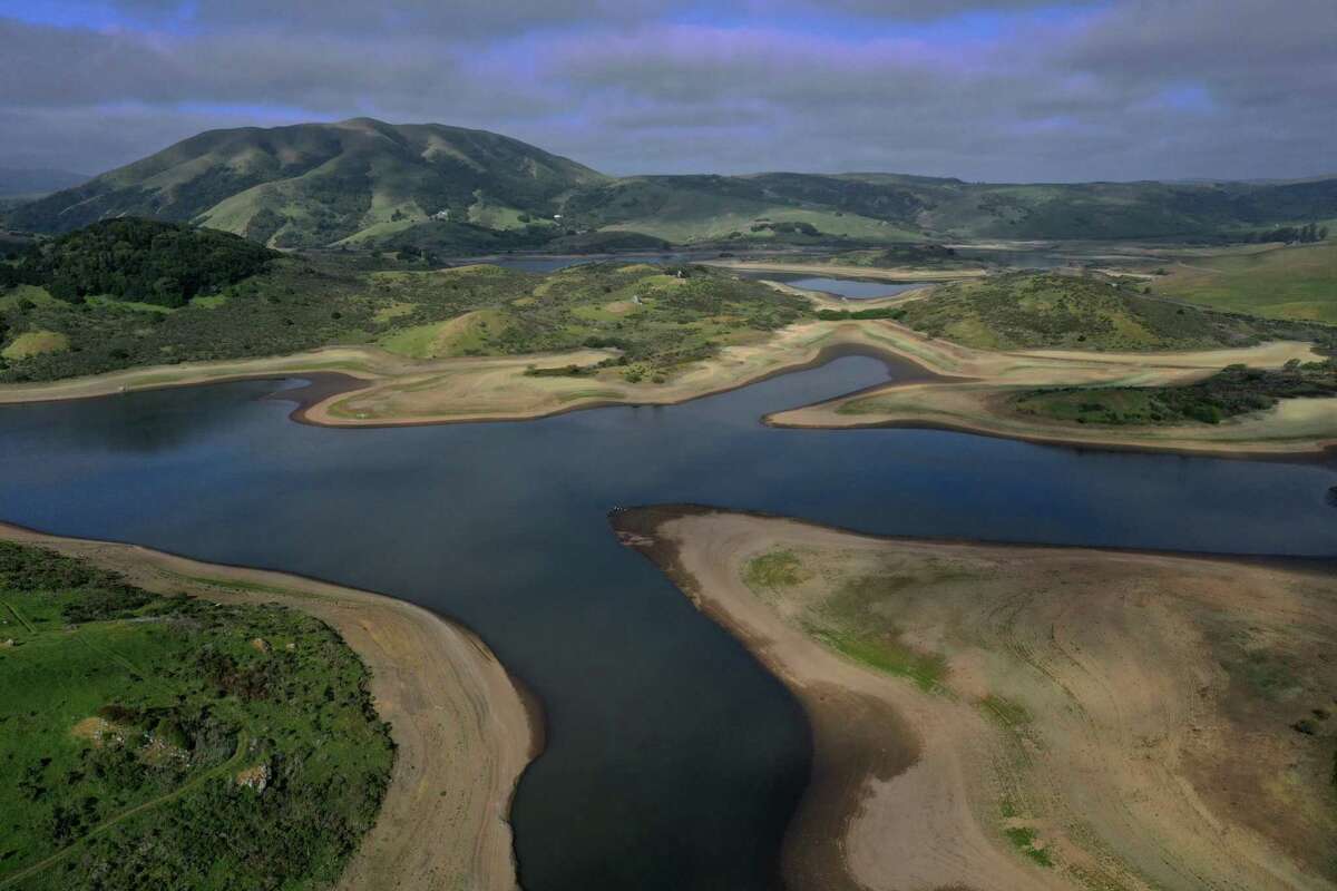 The Nicasio Reservoir in Marin County reveals the low water levels plaguing California reservoirs. As a heat wave exacerbates the state’s drought, Gov. Gavin Newsom has asked residents to voluntarily cut their water use by 15% and extended an emergency drought declaration to nearly every Bay Area county, including Marin.