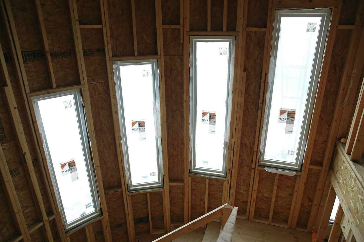 Insulated windows adorn a staircase in the home being built for Gina and Robert Martinez. Builders are recommending that clients order products like these as early as possible during the construction process to ensure they arrive on time, or at least not too late.