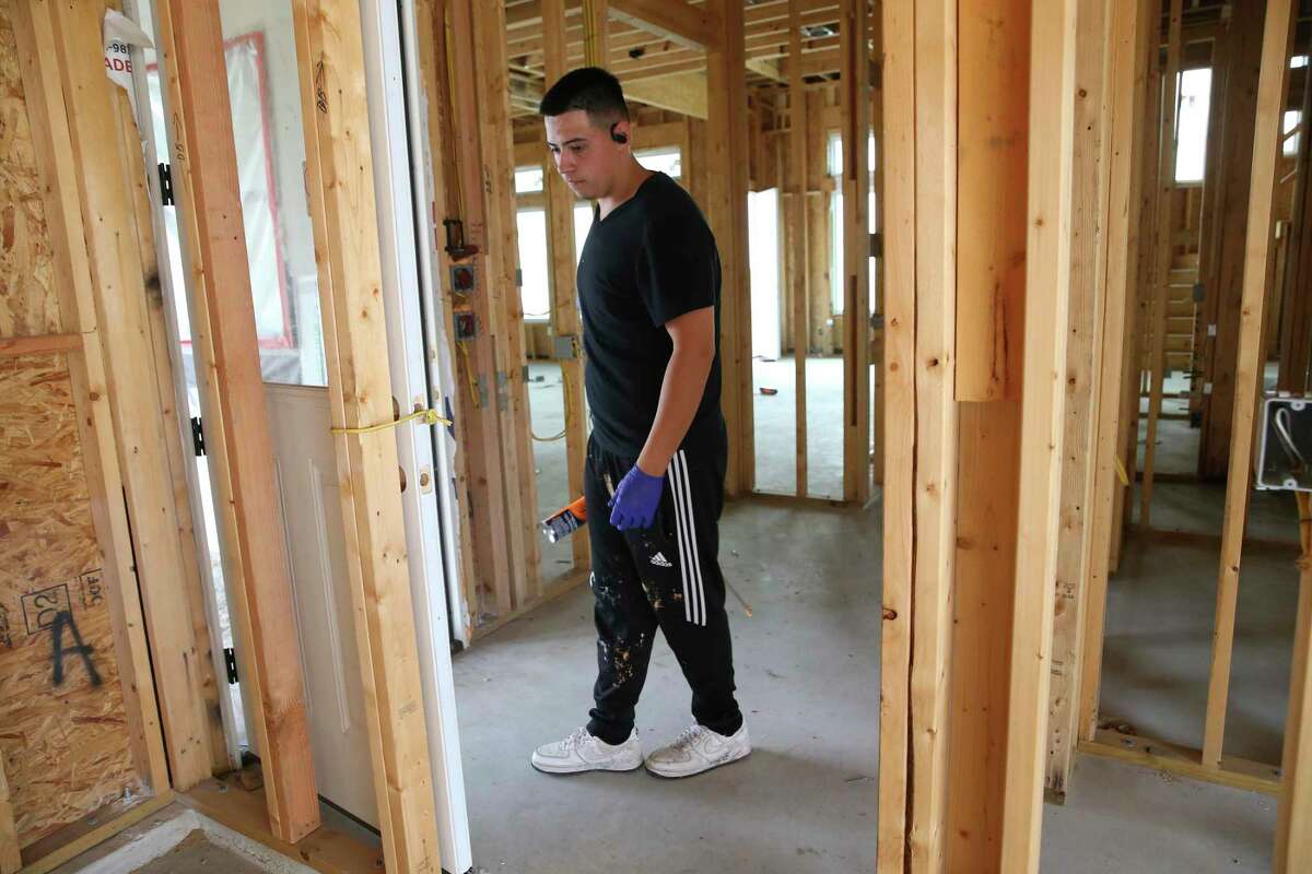 A worker prepares a house for foaming insulation in the home being built for Gina and Robert Martinez in the Canyons at Scenic Loop subdivision. February's arctic storms damaged petrochemical plants up and down the Gulf Coast, resulting in a 30 percent increase in the cost of the product.
