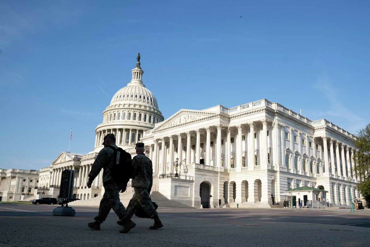 The U.S. Capitol is seen as national guard members pass by on Capitol Hill in Washington, Thursday, May 20, 2021. The House voted to create an independent commission on the deadly Jan. 6 insurrection at the U.S. Capitol, sending the legislation to an uncertain future in the Senate.