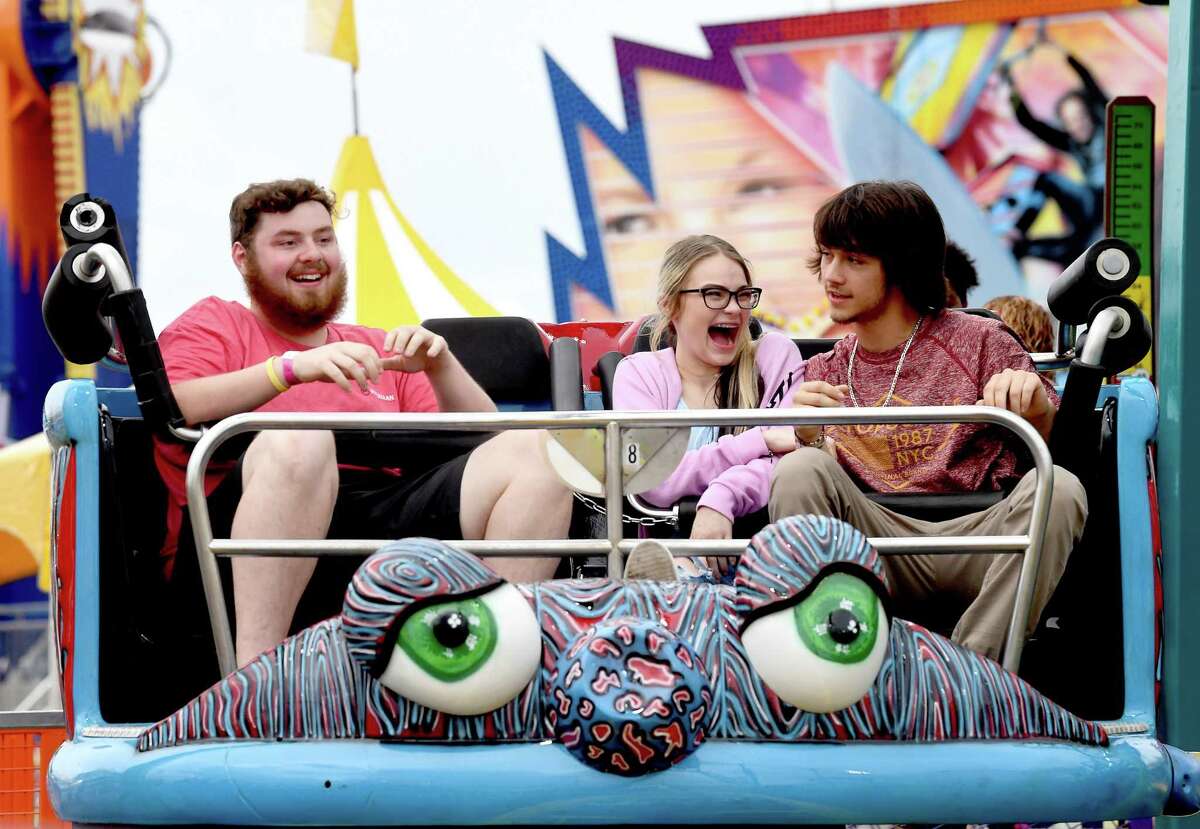 Families and friends enjoy the thrills of the carnival rides on the opening night of the YMBL South Texas State Fair Thursday. Photo made Thursday, May 20, 2021 Kim Brent/The Enterprise