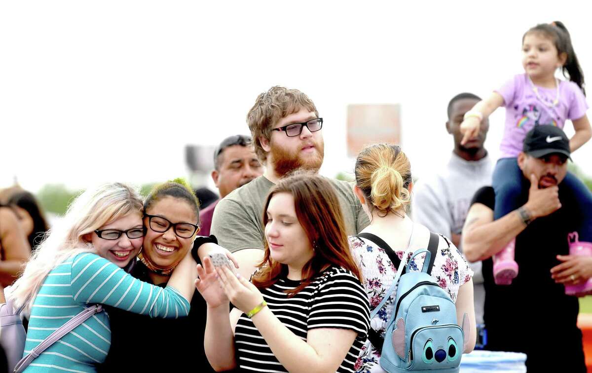 Friends joke as they wait outside the gates for the opening night of the YMBL South Texas State Fair Thursday. Photo made Thursday, May 20, 2021 Kim Brent/The Enterprise