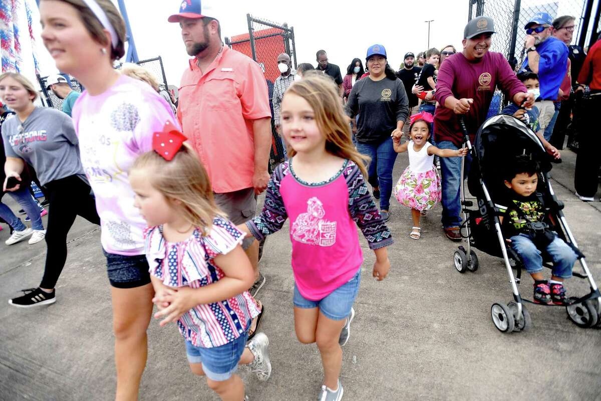 Families and friends hurry in after the gates part on the opening night of the YMBL South Texas State Fair Thursday. Photo made Thursday, May 20, 2021 Kim Brent/The Enterprise