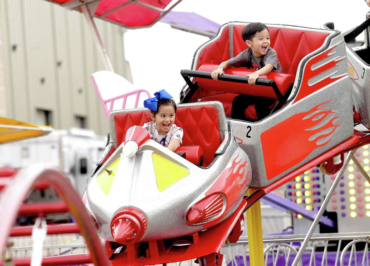Families and friends enjoy the thrills of the carnival rides on the opening night of the YMBL South Texas State Fair Thursday. Photo made Thursday, May 20, 2021 Kim Brent/The Enterprise