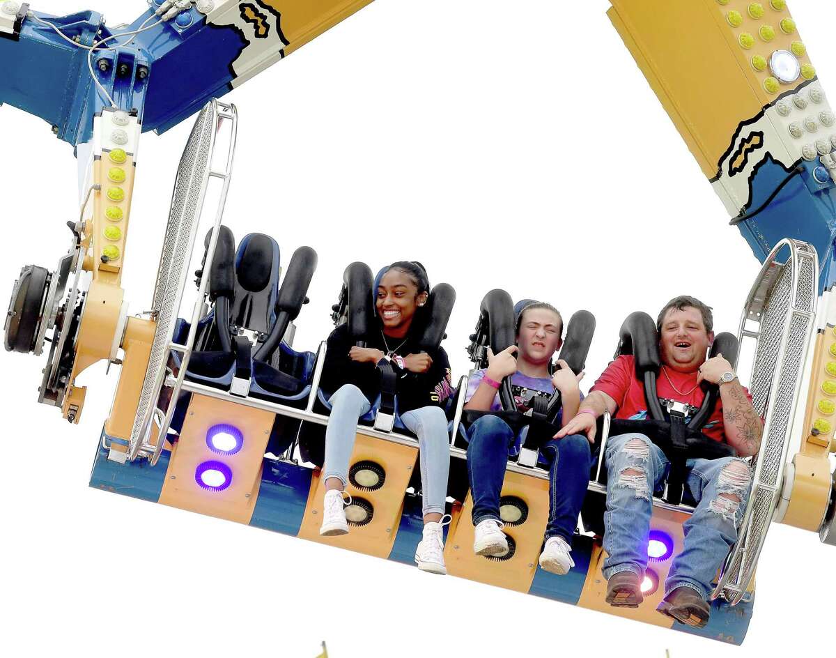 Families and friends enjoy the thrills of the carnival rides on the opening night of the YMBL South Texas State Fair Thursday. Photo made Thursday, May 20, 2021 Kim Brent/The Enterprise