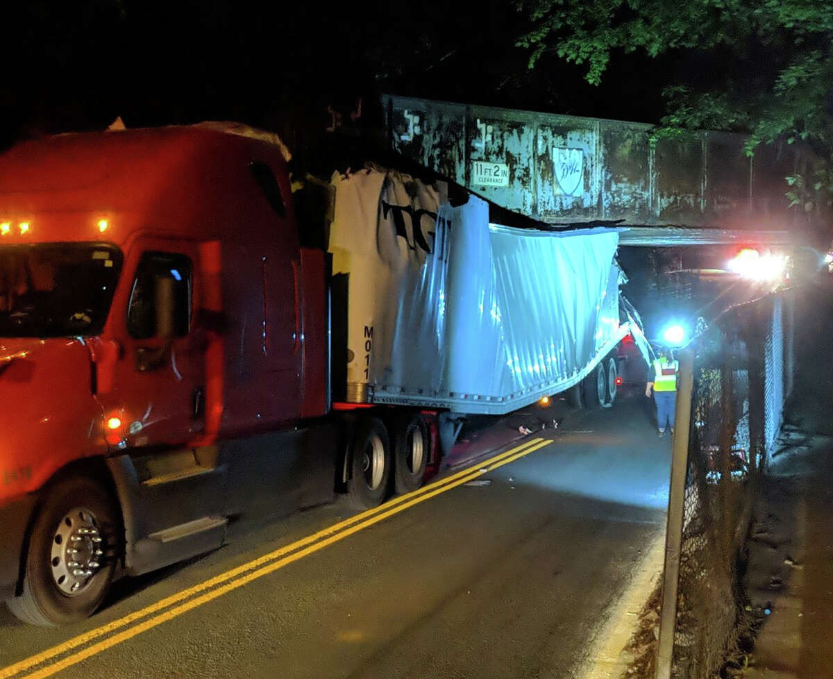 A main route through Bethlehem will be closed for an extended period of time, according to Bethlehem Police after a tractor-trailer struck and became wedged under a bridge in Slingerlands.