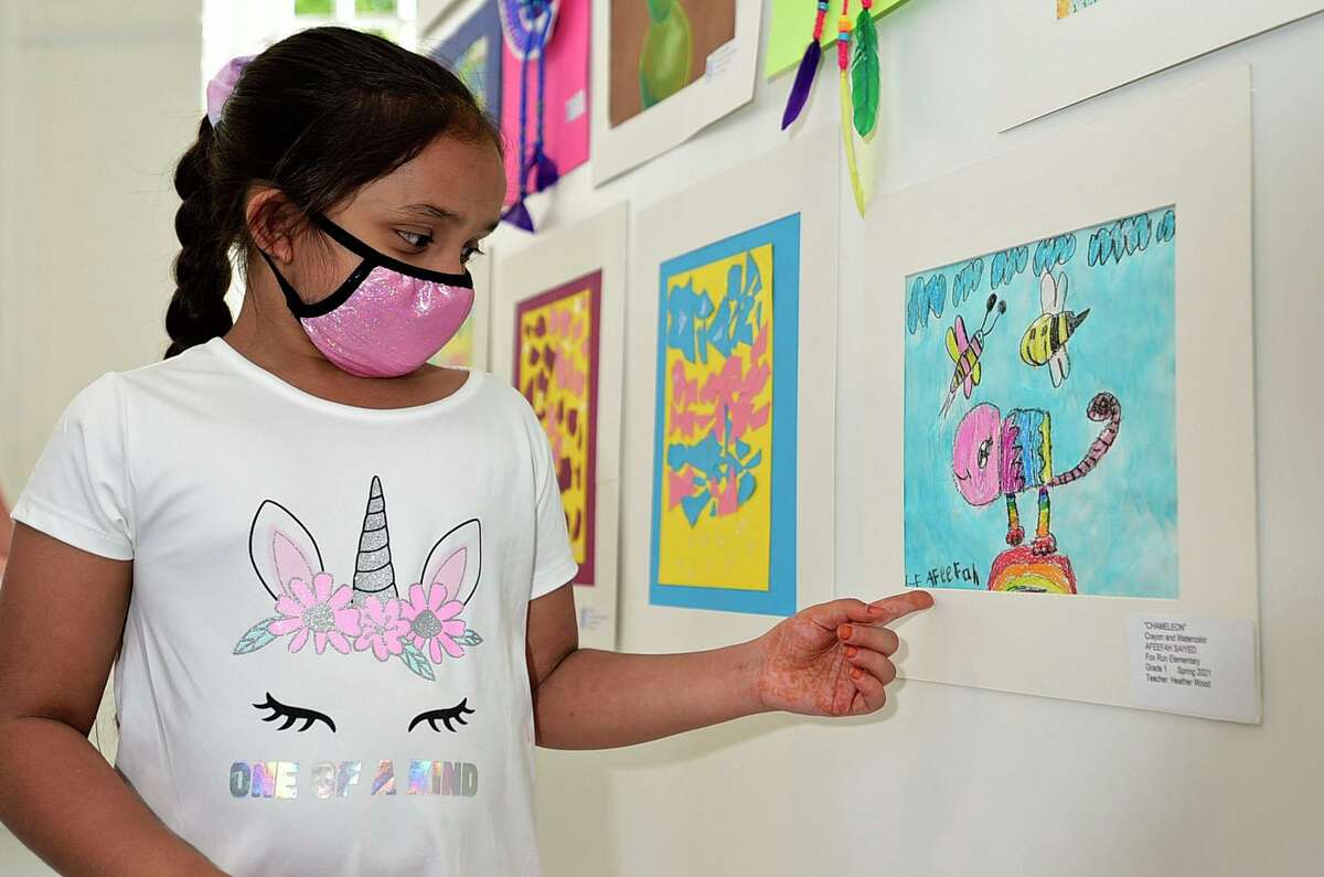 Fox Run Elementary School first grader Afeefah Saiyed points out her work at the opening night of the annual Norwalk citywide art show Thursday, May 20, 2021, at the Art Space in Norwalk, Conn.
