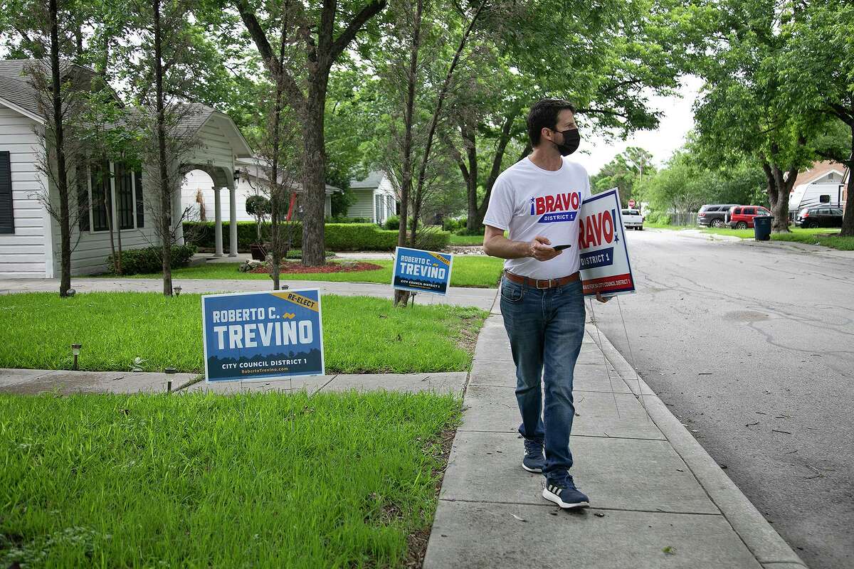 San Antonio City Council District 1 candidate Mario Bravo looks for an address as he blockwalks in San Antonio on May 18, 2021.