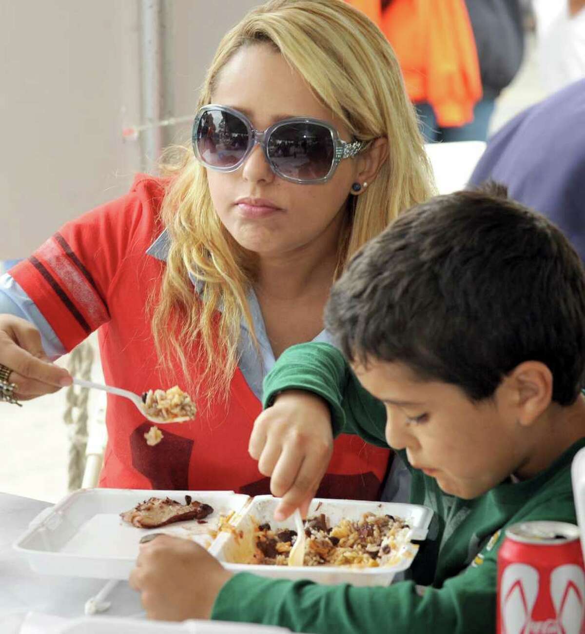 Roberta Maia of Danbury shares a Brazilian dish with her son Caleb, 8, at the Taste of Danbury Sunday, Sept. 12, 2010.