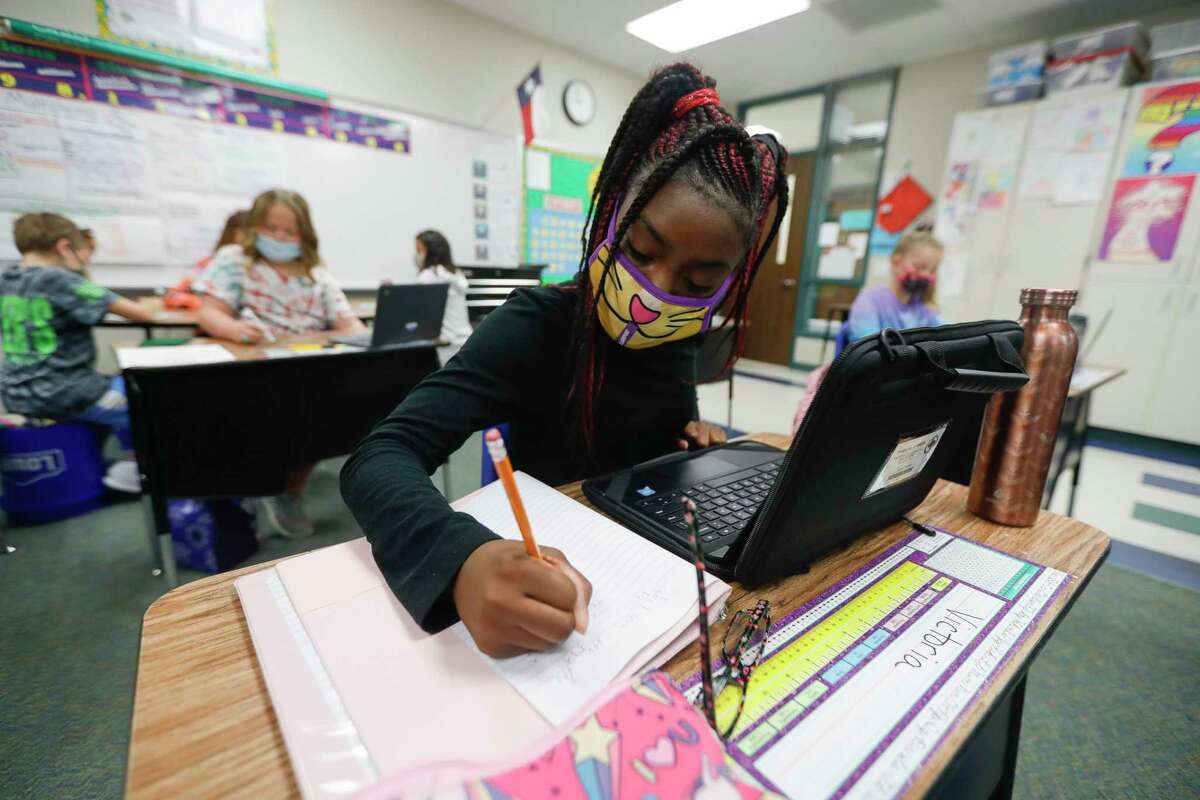Then-fifth grader Victoria Thomas uses her laptop to work on math at William Loyd Meador Elementary School, Thursday, Sept. 10, 2020, in Willis. Gov. Greg Abbott issued an executive order last month that bars school districts from mandating masks for students, teachers or visitors.