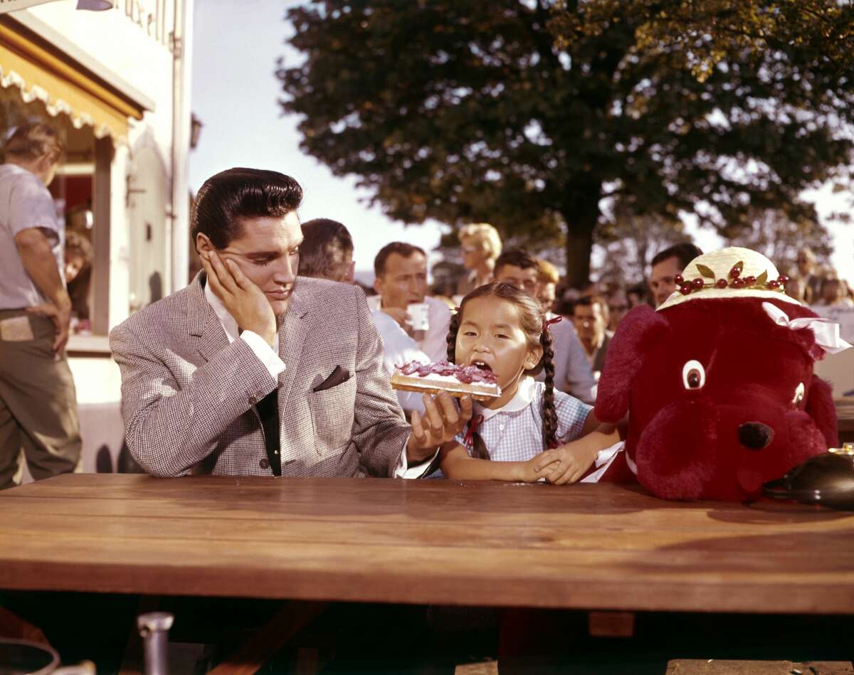 American singer, actor Elvis Presley and Philippine actress Vicky Tiu on the set of "It Happened at the World's Fair" directed by Norman Taurog. (Photo by Sunset Boulevard/Corbis via Getty Images)