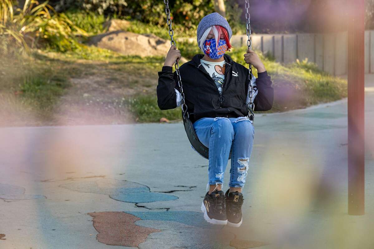 Ella Guadarrama (11) swings at the Helen Diller Playground in Mission Dolores Park on Thursday, May 20, 2021, in San Francisco, Calif.