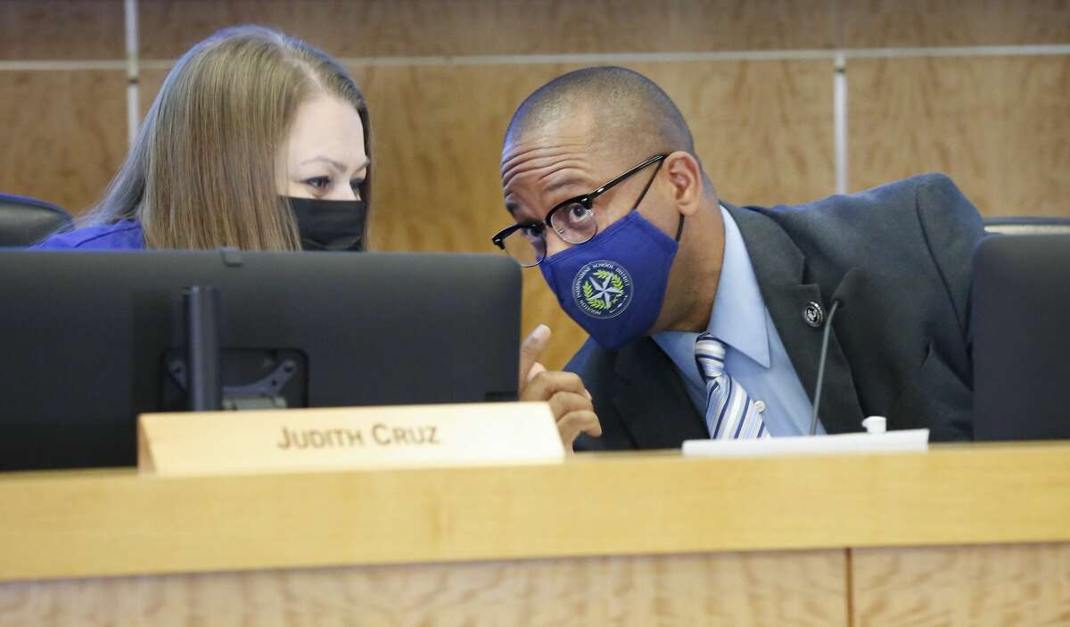 Houston Independent School District superintendent Millard House II (right) chats with HISD Board member Judith Cruz as the media entered the room May 21, 2021, in Houston.