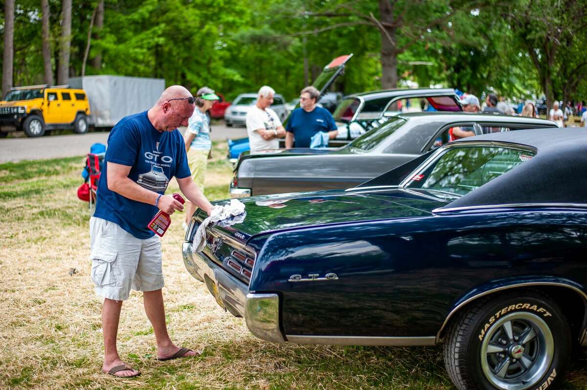 Hope resident Jay Person wet details his '67 Pontiac GTO at a car show on May 21, 2021 in Porte Park, Sanford. The car show was a part of the 'Sanford Rising" week.