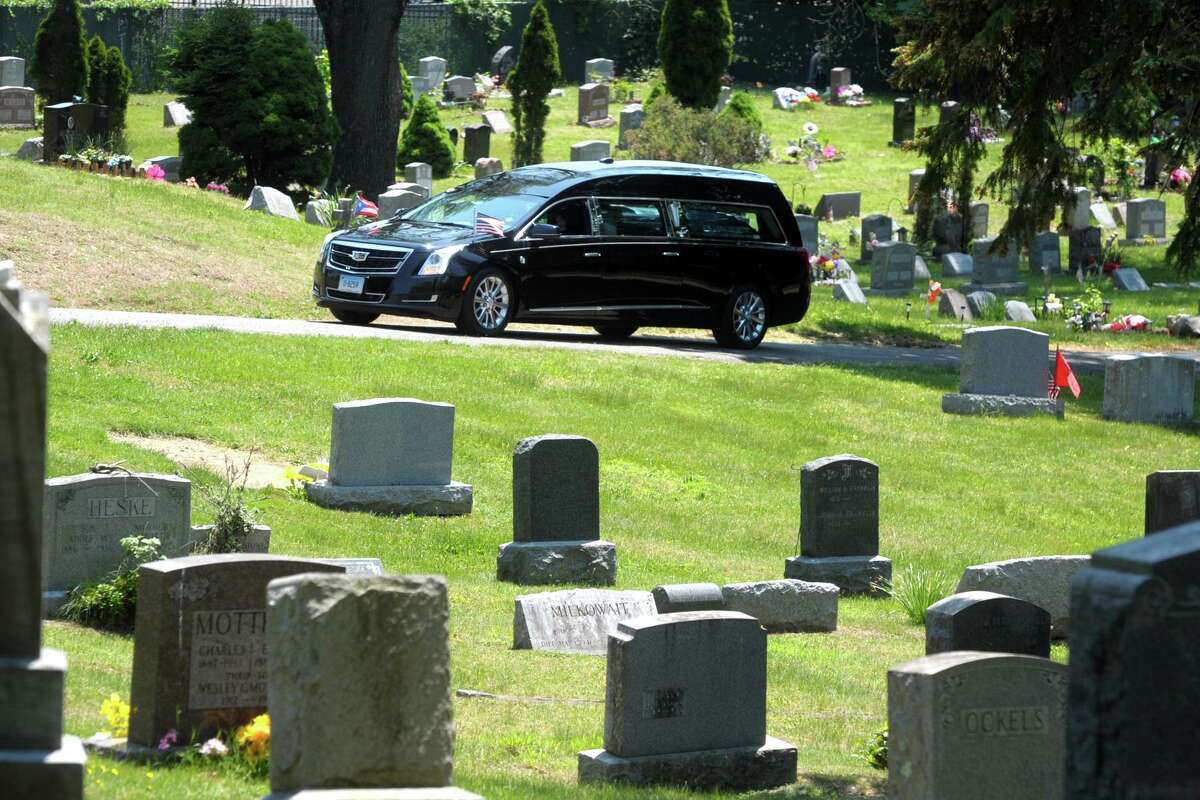 A hearse enters Park Cemetery for a funeral in Bridgeport, Conn. May 21, 2021.