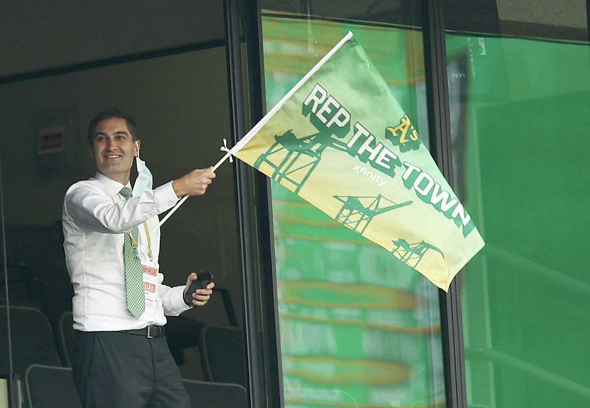 OAKLAND, CALIFORNIA - OCTOBER 01: Oakland Athletics team president Dave Kaval waves a flag after they tied their game against the Chicago White Sox in the fourth inning of Game Three of the American League wild card series at RingCentral Coliseum on October 01, 2020 in Oakland, California. (Photo by Ezra Shaw/Getty Images)