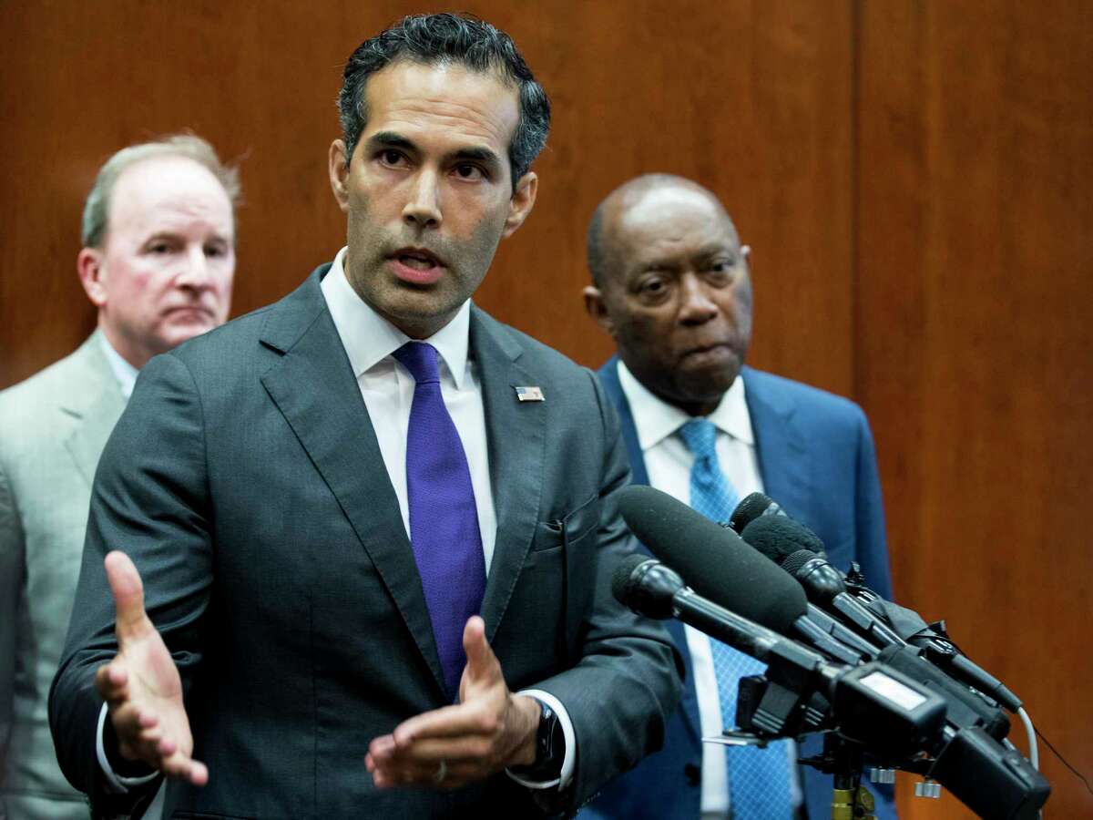 George P. Bush, commissioner of the General Land Office, stands with Mayor Sylvester Turner as he discusses long-term Hurricane Harvey recovery funds during a news conference at the Houston City Hall Annex on Thursday, June 28, 2018, in Houston. Bush on Friday blamed city and county officials for their failure to receive any of the first $1 billion in funding announced Friday. Turner and Harris County Judge Lina Hidalgo blamed criteria developed by GLO that they said disadvantaged populous areas. ( Brett Coomer / Houston Chronicle )