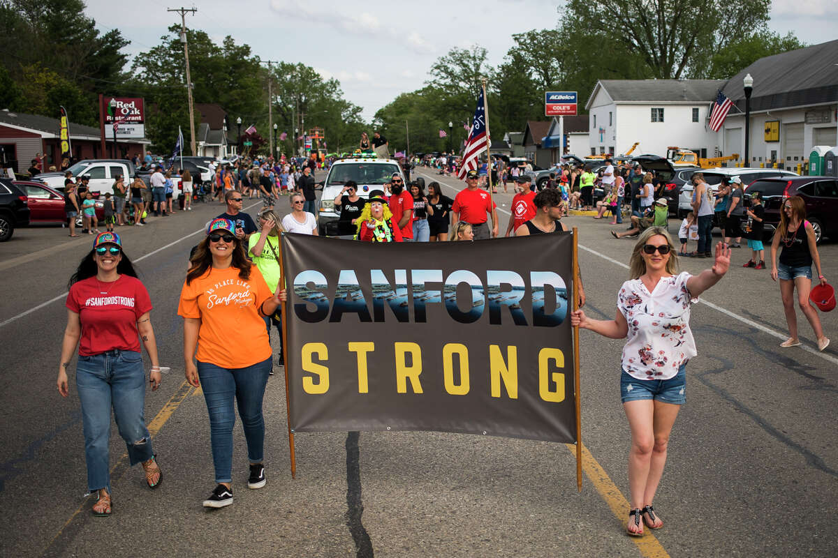 Hundreds of people line Saginaw Road to watch a parade during the Sanford Rising celebration Friday, May 21, 2021 in downtown Sanford.