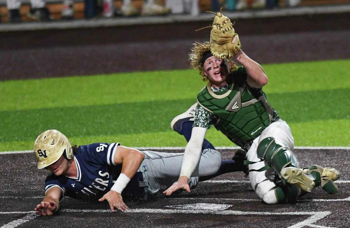 Reagan catcher Ryan Beaird checks for the ball in his glove after tagging out Christian Keller of Smithson Valley during Game 2 of the 6A regional quarterfinal series at North East Sports Park on Friday, May 21, 2021. Reagan won, 4-1.