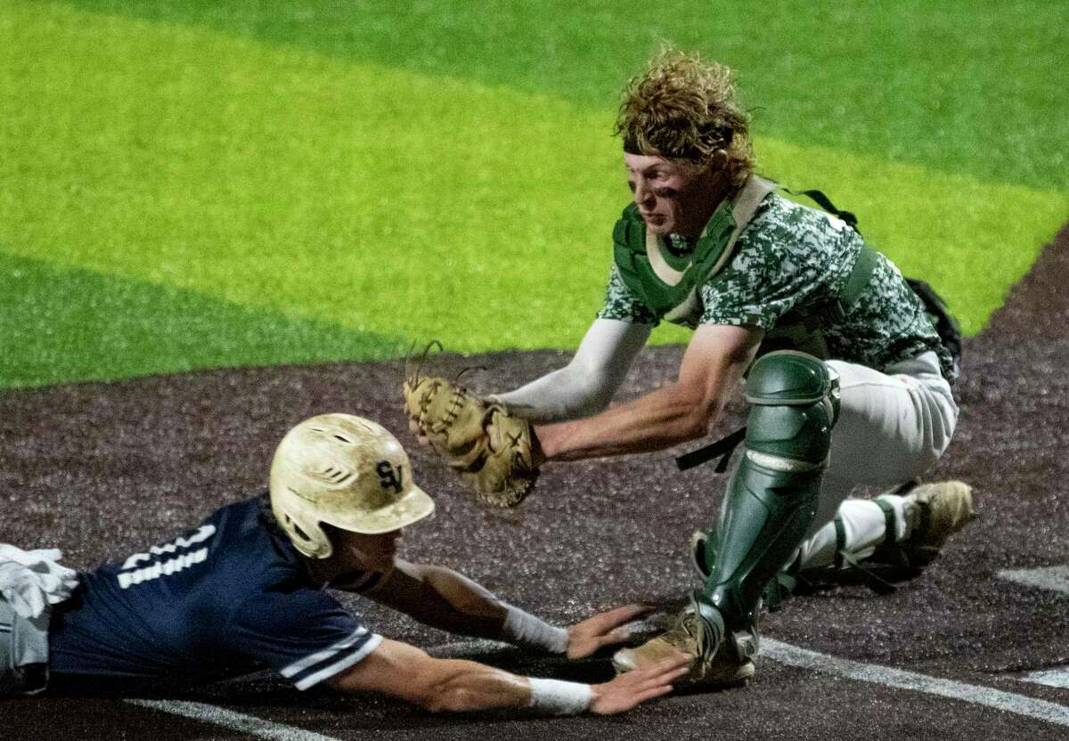 Reagan catcher Ryan Beaird tags out Christian Keller of Smithson Valley during the sixth inning of Game 2 of the 6A regional quarterfinal series at North East Sports Park on Friday, May 21, 2021. Reagan won, 4-1.