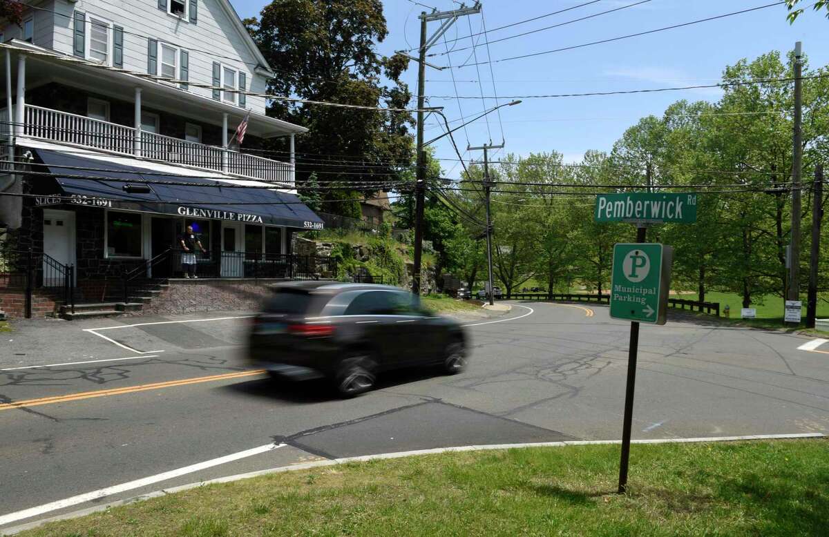 A car passes by Glenville Pizza at the intersection of Glenville Road and Pemberwick Road, where pedestrian safety improvements are being sought out, in the Glenville section of Greenwich, Conn. Thursday, May 20, 2021. A new committee is working on beautifying and improving Glenville's public spaces, parks, roads, and sidewalks.