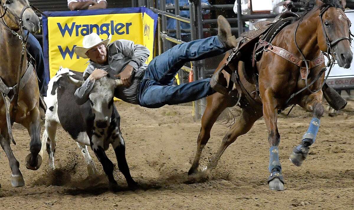 Riders compete in the 75th annual PRCA rodeo on its opening night at the YMBL South Texas State Fair Friday. Photo made Friday, May 21, 2021 Kim Brent/The Enterprise