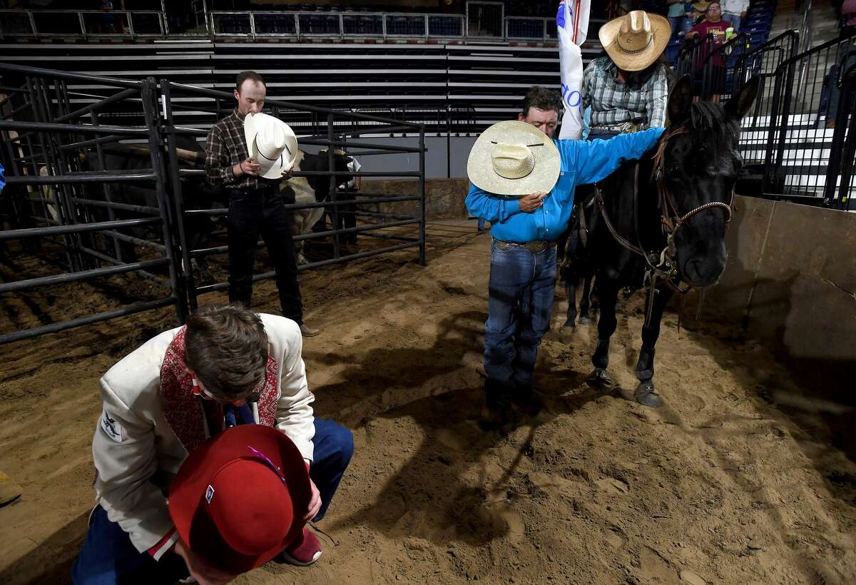 Rodeo participants observe an opening prayer during the 75th annual PRCA rodeo on its opening night at the YMBL South Texas State Fair Friday. Photo made Friday, May 21, 2021 Kim Brent/The Enterprise