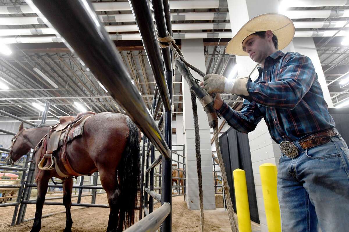 Toby Collins preps his ropes before competing in the 75th annual PRCA rodeo on its opening night at the YMBL South Texas State Fair Friday. Photo made Friday, May 21, 2021 Kim Brent/The Enterprise