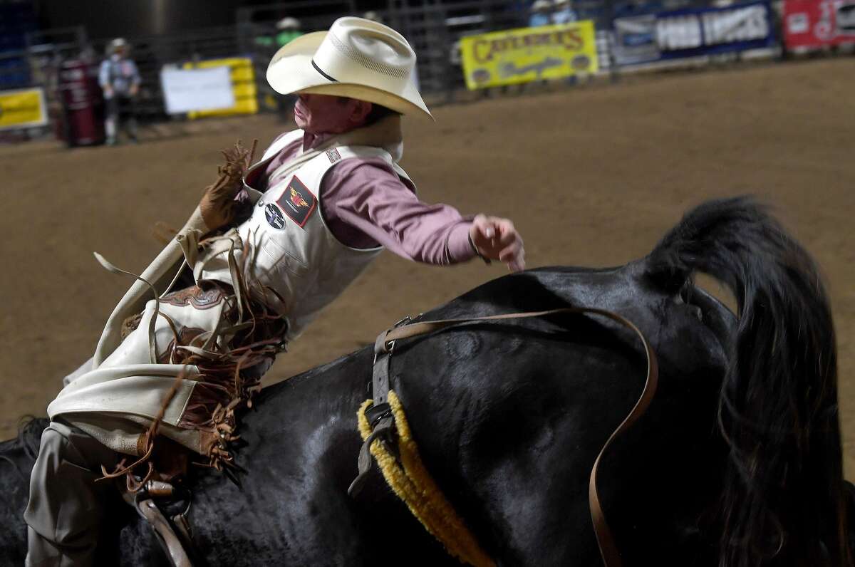 Riders compete in the 75th annual PRCA rodeo on its opening night at the YMBL South Texas State Fair Friday. Photo made Friday, May 21, 2021 Kim Brent/The Enterprise