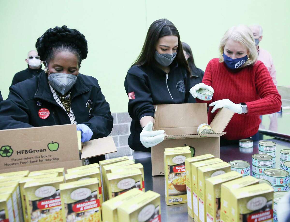 From left, U.S. Representatives Sheila Jackson Lee, Alexandria Ocasio-Cortez, and Sylvia Garcia, fill boxes at the Houston Food Bank on Saturday, Feb. 20, 2021. President Joe Biden declared a major disaster in Texas on Friday, directing federal agencies to help in the recovery. (Elizabeth Conley/Houston Chronicle via AP)