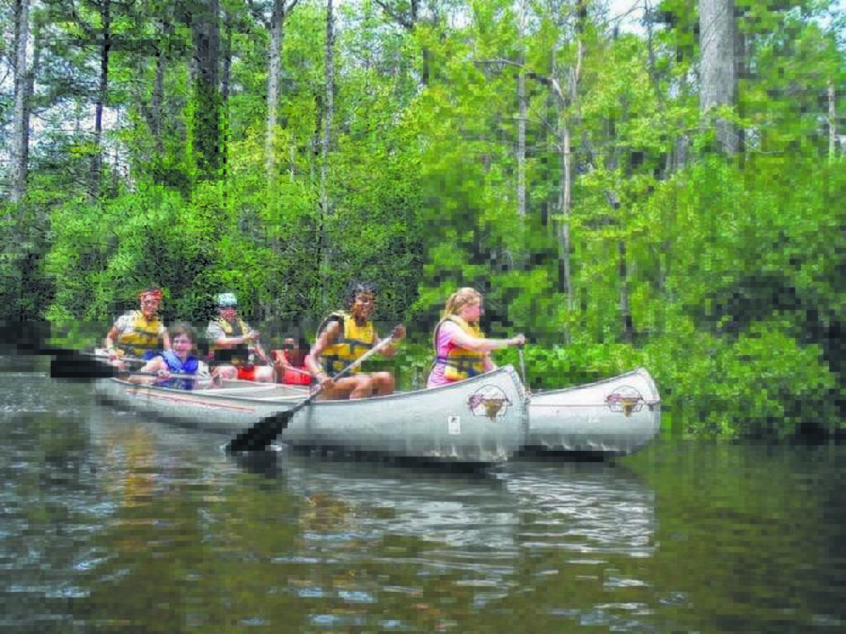 Scouts canoe at one of the many outdoor Girl Scout camp activities. First summer day camp is in Edwardsville June 17-18.