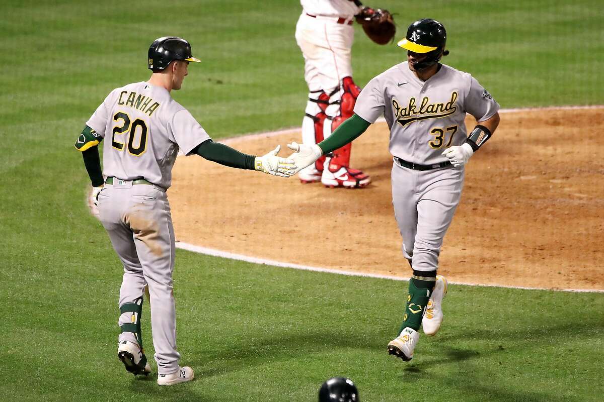 ANAHEIM, CALIFORNIA - MAY 22: Aramis Garcia #37 of the Oakland Athletics celebrates his home run with Mark Canha #20 during the seventh inning against the Los Angeles Angels at Angel Stadium of Anaheim on May 22, 2021 in Anaheim, California. (Photo by Katelyn Mulcahy/Getty Images)