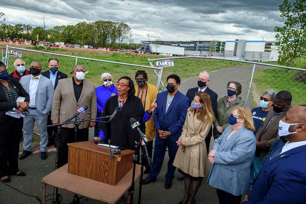 Windsor Town Council member Nuchette Black-Burke, center, with state and local elected leaders together with the CT NAACP, speaks out at news conference May 7, 2021, in Windsor, Conn., after a noose was found at an Amazon warehouse construction site.