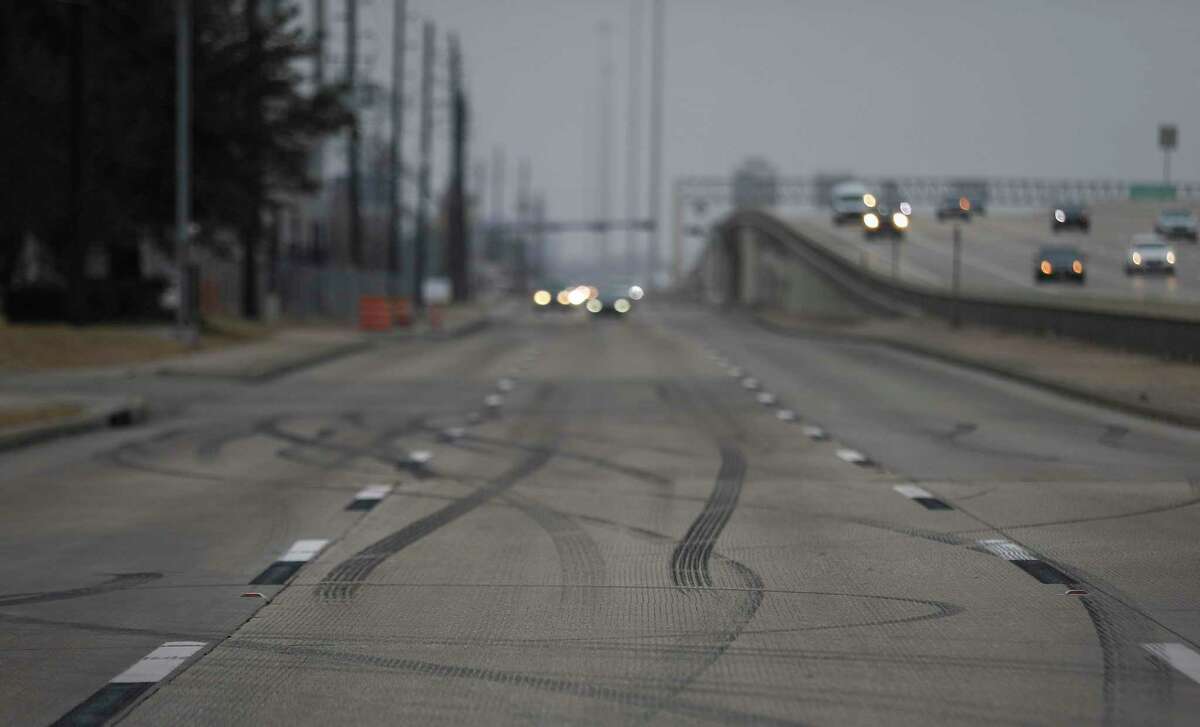 Tire marks are seen on the feeder road at the site of a car meet held Sunday, where authorities said a street takeover happened and a crash resulted in the deaths of three people. The site was photographed Thursday, Feb. 25, 2021, in Houston.