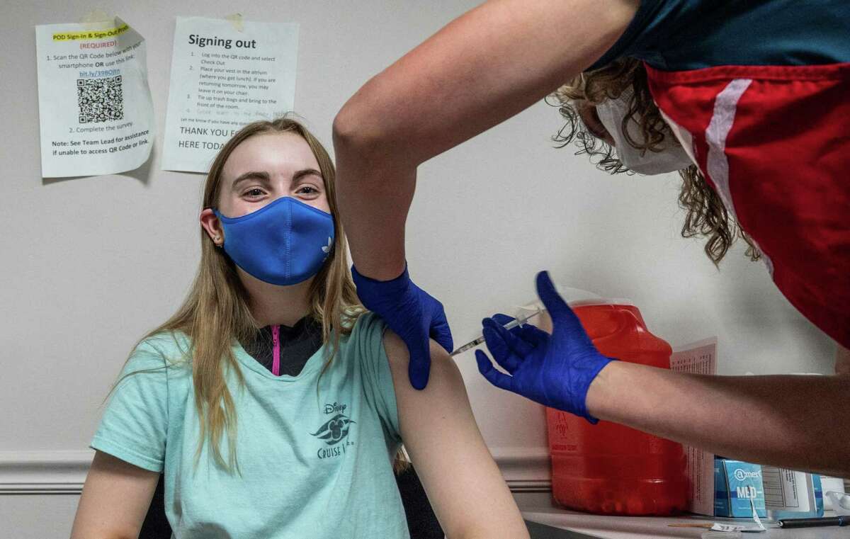 Audrey Vakker, 14, getS a COVID-19 vaccination in Fairfax, Va., on May 13, 2021. Health authorities are looking into reports of heart inflammation among some younger people who received COVID vaccines, with no clear link established for the moment.