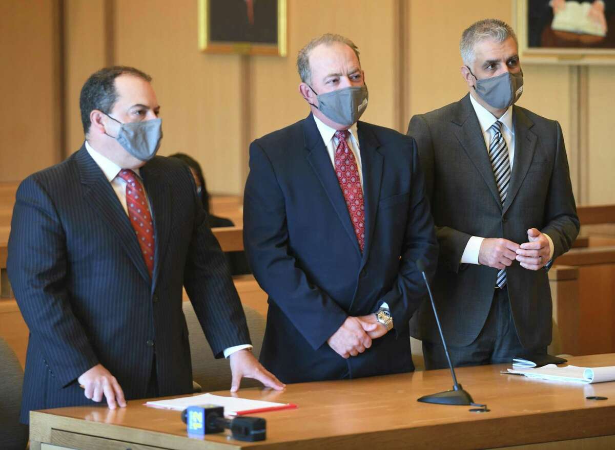 Kent Mawhinney, center, the longtime lawyer and friend of Fotis Dulos, appears in court with his lawyers Lee Gold, left, and Jeffrey Kestenband at the Connecticut Superior Court in Stamford, Conn. Tuesday, May 18, 2021. Mawhinney has pleaded not guilty to conspiracy to commit murder in the May 2019 death and disappearance of New Canaan mother-of-five Jennifer Dulos. Mawhinney and his lawyers appeared in court Tuesday asking for the removal of his GPS tracking device so that Mawhinney could put on skates and referee hockey games, which the judge denied.