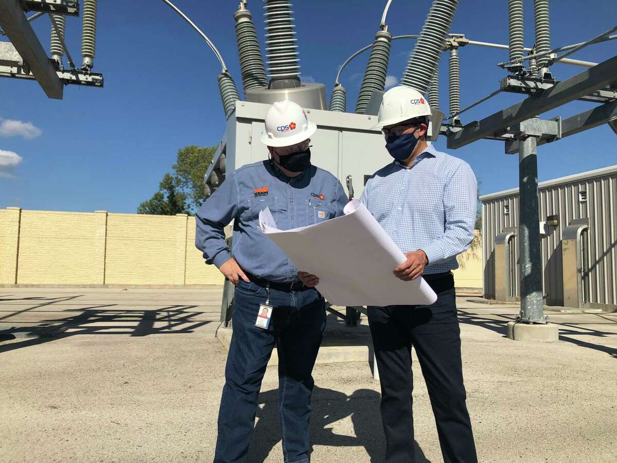 Fred Bonewell, left, CPS chief security, safety and gas solutions officer, reviews sketches with Richard Medina, CPS vice president of grid transformation and engineering at a power substation. CPS is part of a collaboration between Joint Base San Antonio, the city and dozens of other organizations working to strengthen the grid against threats from electromagnetic disturbances.