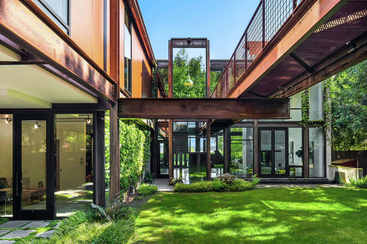 Kundig's love of angles is never overly industrial because his use of glass creates a mirror-like effect with the surrounding greenery. 